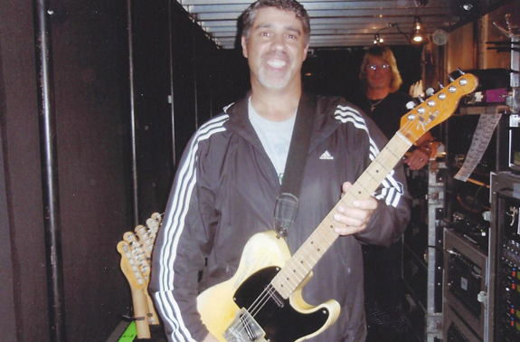 Gary holding Springsteen's guitar backstage at Giants Stadium