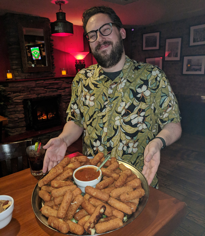 JD Harmeyer holding a platter of mozzarella sticks at his bachelor party