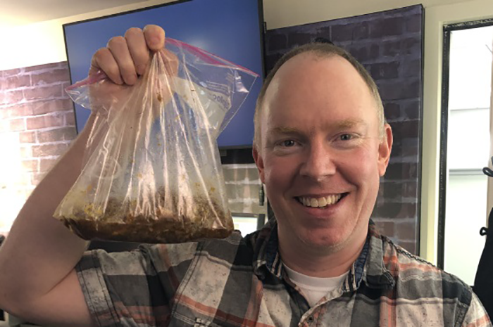 Richard Christy holding a bag of food he brought in for lunch