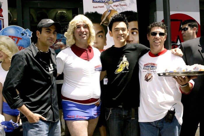 Jason Kaplan as a woman and Gary Dell'Abate with stars Kal Penn and John Cho at a “Harold & Kumar Go to White Castle” event